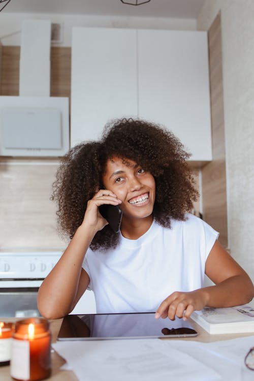 A Smiling Woman Having a Conversation on the Phone