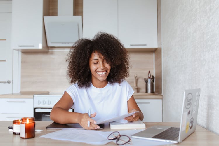 A Happy Woman Holding A Document