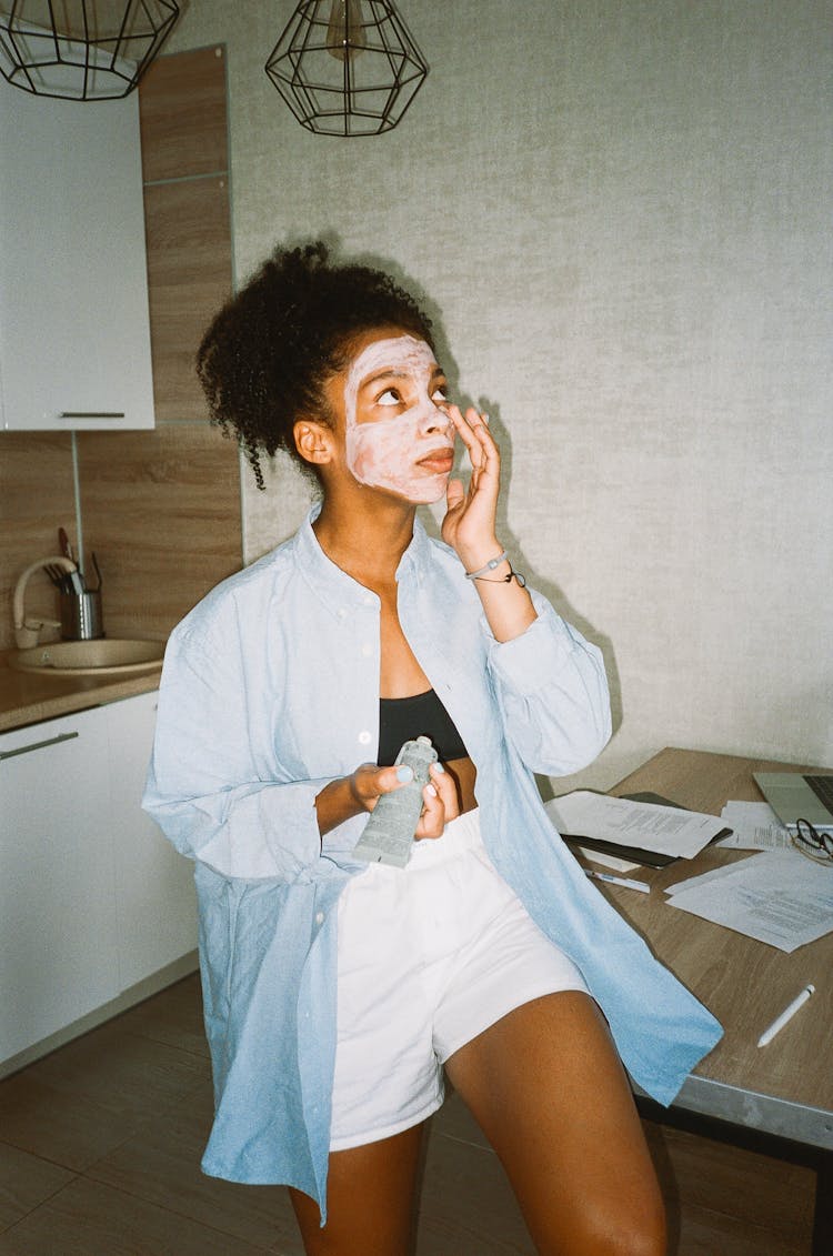 A Woman Putting Cream On Her Face