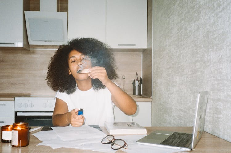 A Woman Lighting A Palo Santo Incense