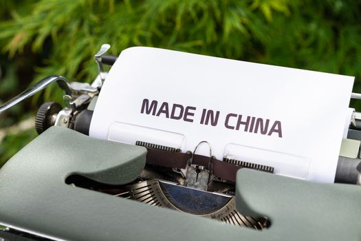 一台老式打字机特写，上面打着“中国制造”，被放置在室外环境中