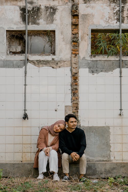 Free Couple Sitting in Abandoned Building Stock Photo