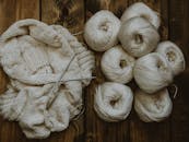 Handmade Sweater and White Yarn Rolls