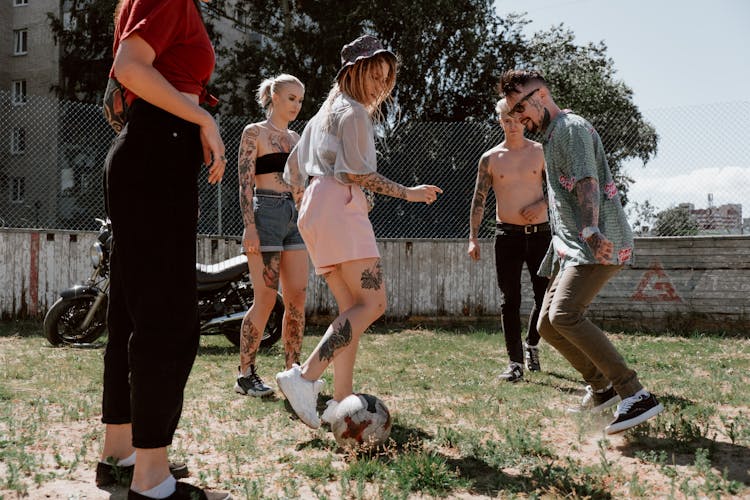 Friends Playing Soccer At A Sandlot