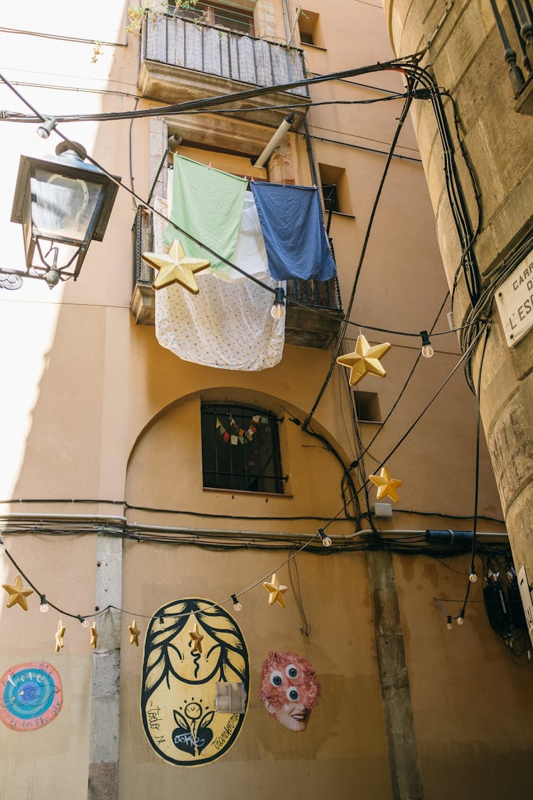 Hanging Bulbs On The Street Between Concrete Buildings