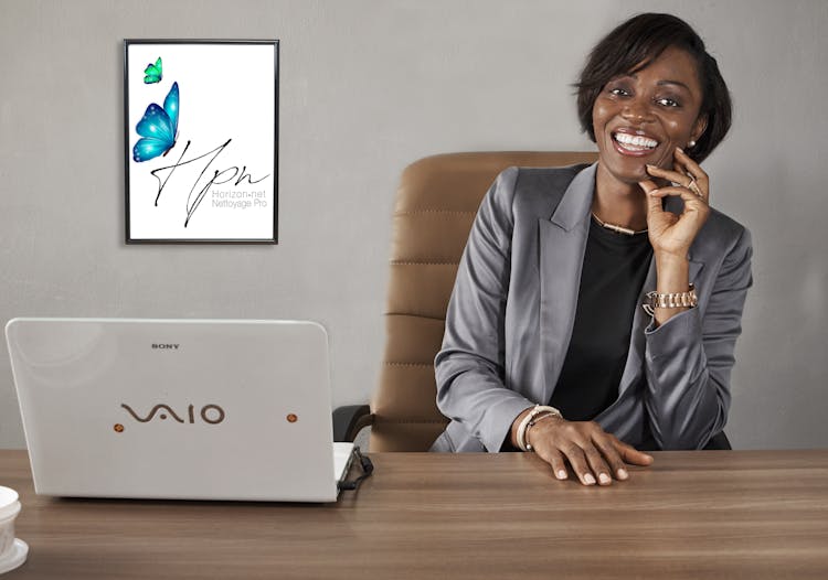 Woman In Gray Blazer Sitting On A Executive Chair