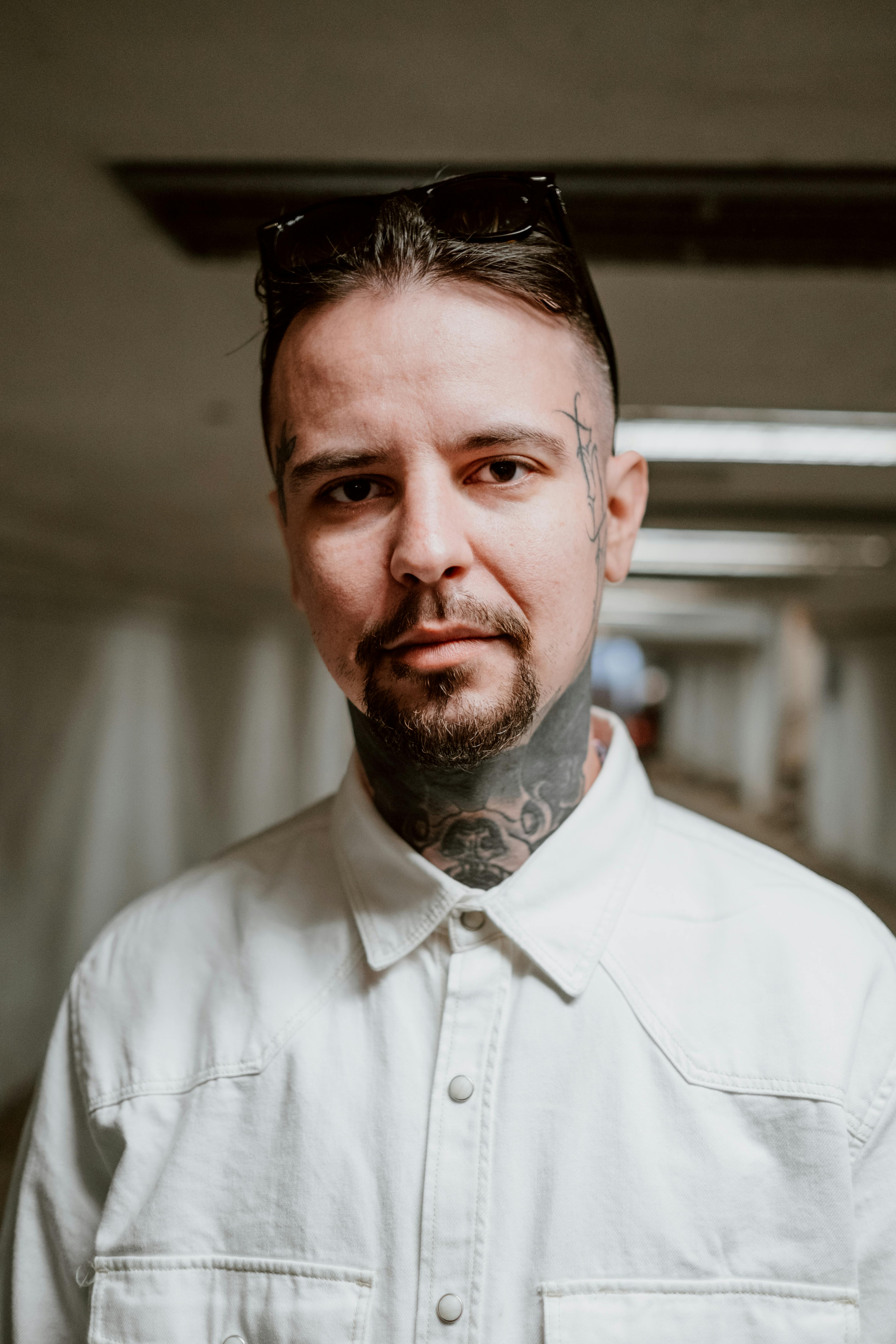 Tattooed Man in White Button Up Shirt