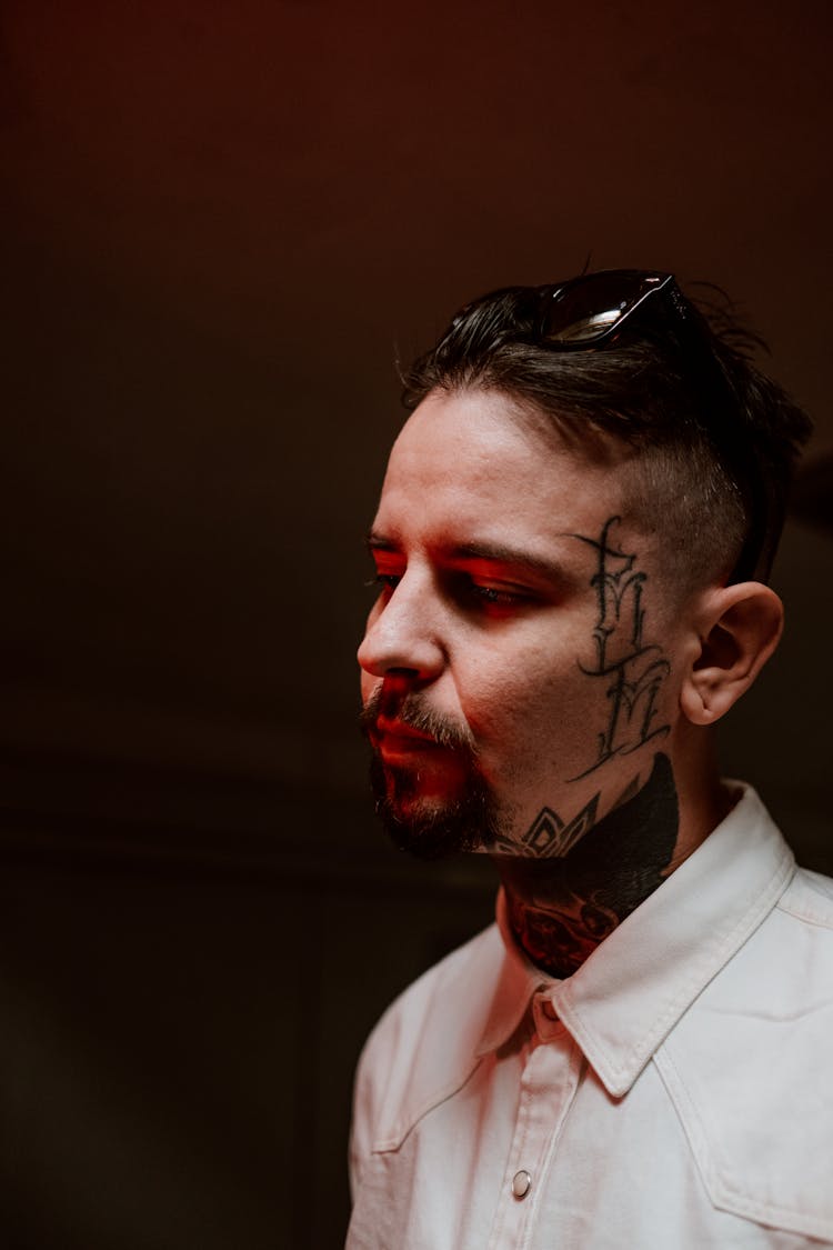 Close-Up Shot Of A Man With A Tattoo On His Face