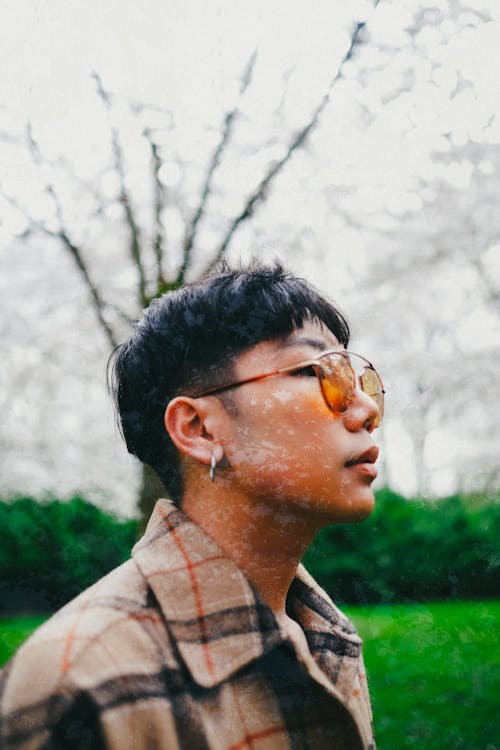 Young Asian man in garden