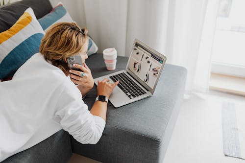 Woman in White Long Sleeves Using a Macbook Air