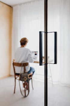 Minimalist home office setup with a person working at a desk.