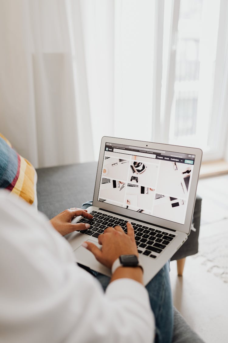 Person In White Long Sleeve Shirt Using Macbook Air