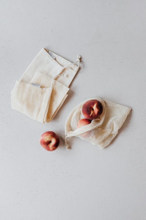 Peaches and Bags on a White Background