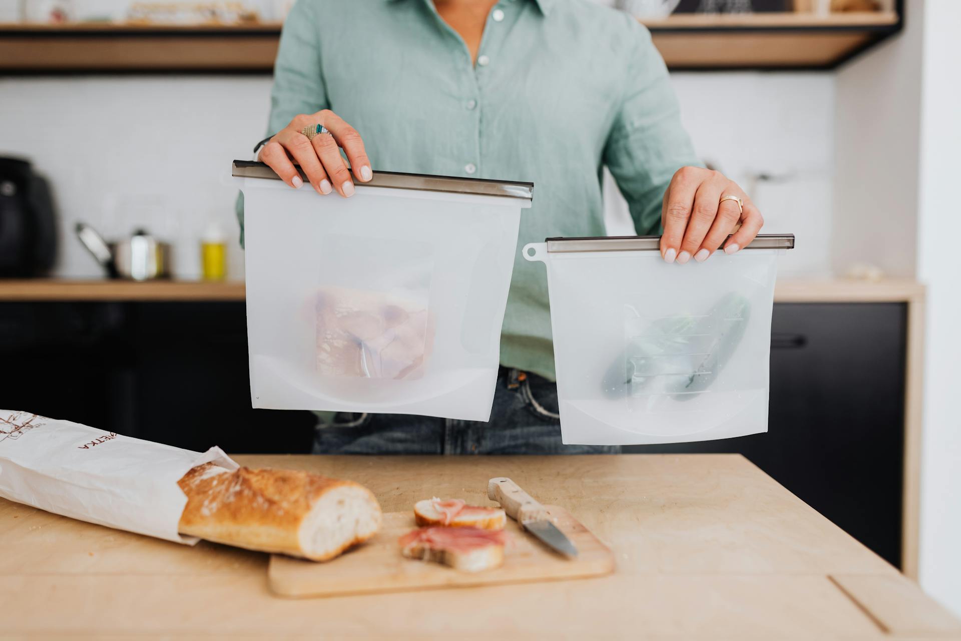 Woman Holding Food Bags in a Kitchen