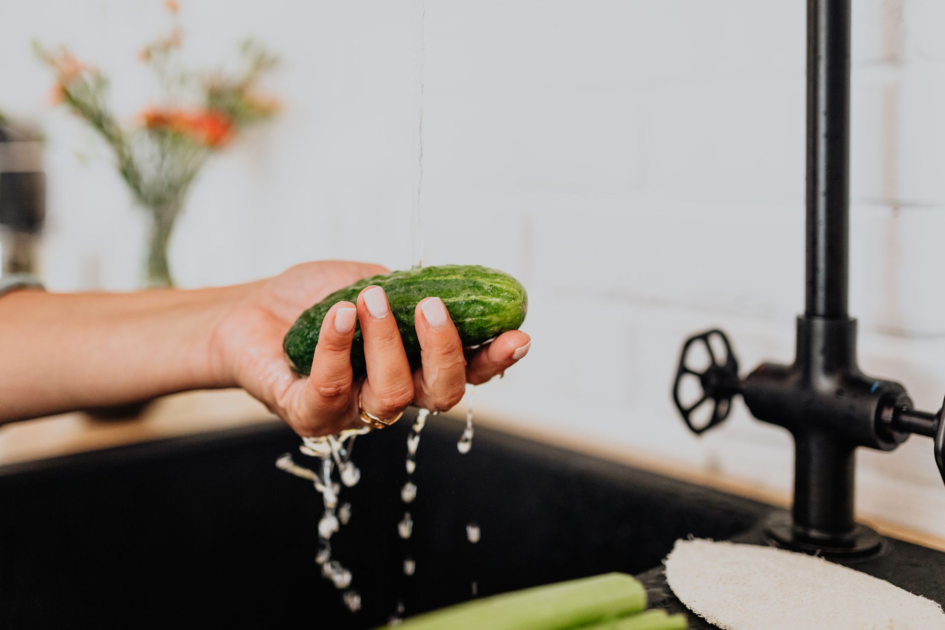 Woman Washing Cucumber under Tap Water