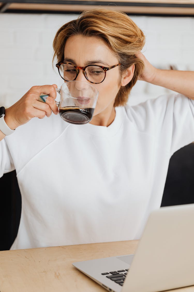 A Woman Drinking A Coffee 