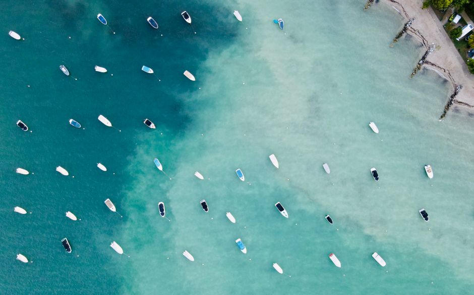Top view of nautical transport on green ocean water near shore in daytime