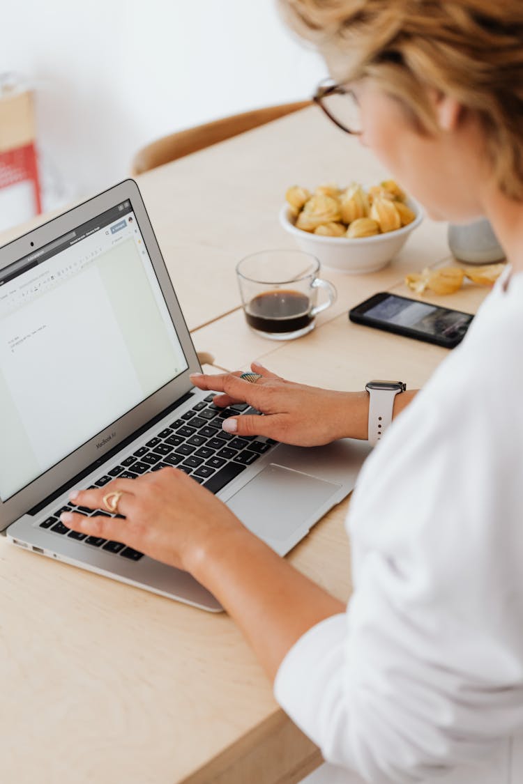 A Woman Typing On The Laptop