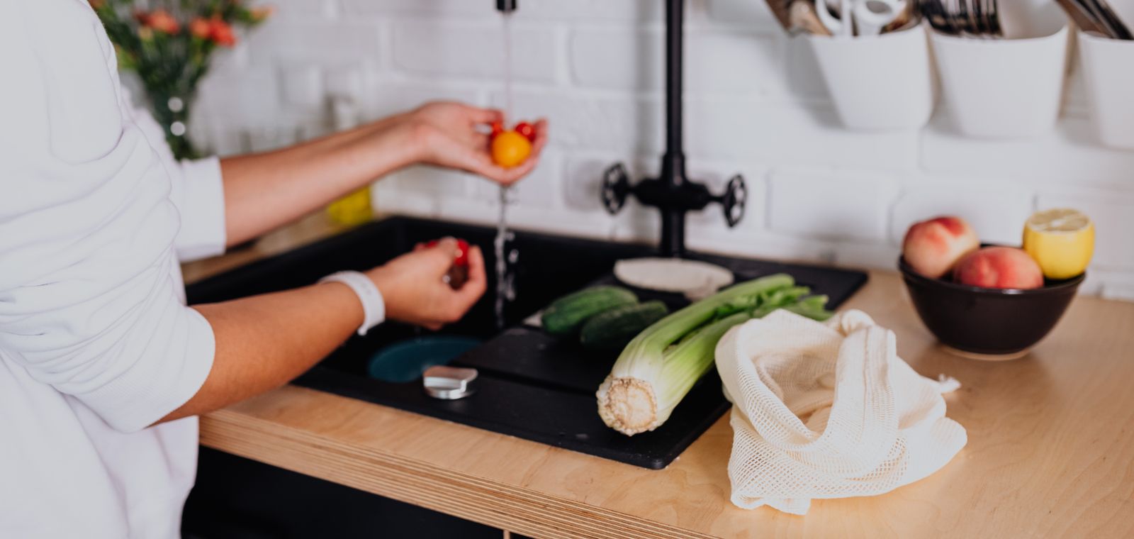 Washing vegetables at the kitchen sink
