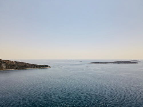 Rippled sea near ridges under sky in evening