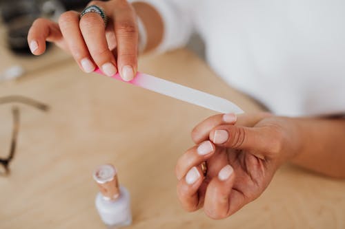 Person Holding White Plastic Spoon