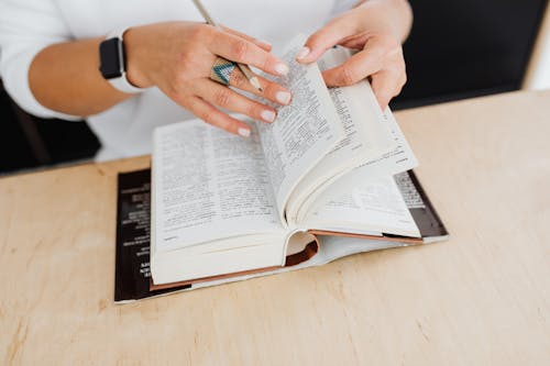 Free Person Wearing Silver Ring Holding White Book Page Stock Photo