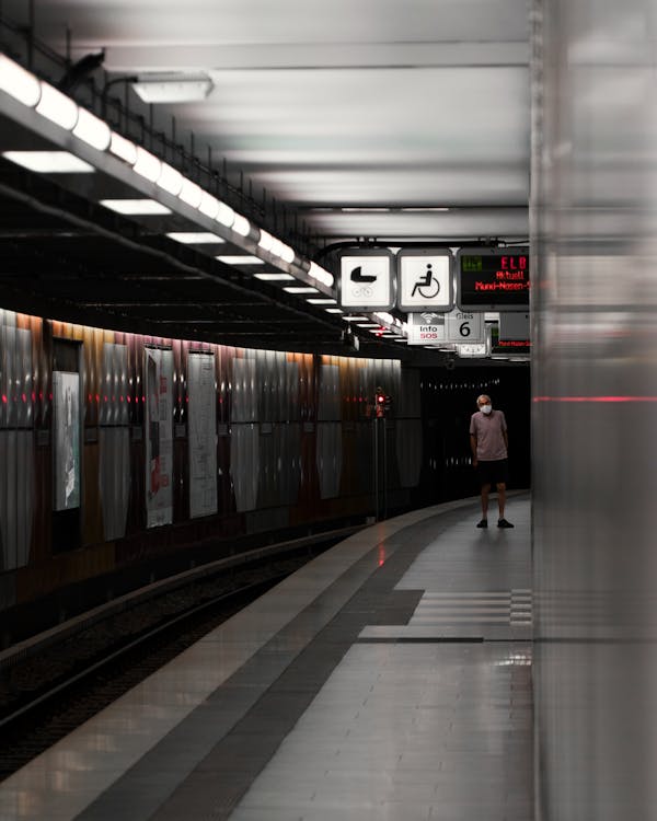 Man Standing on a Subway Station