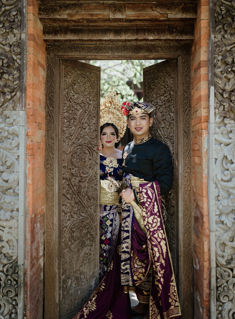 Smiling Asian Couple In Traditional Outfit In Old Building