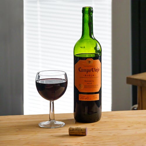 Free Close-Up Shot of a Bottle and Glass of a Red Wine Stock Photo