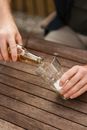 Man filling glass cup with foaming beer