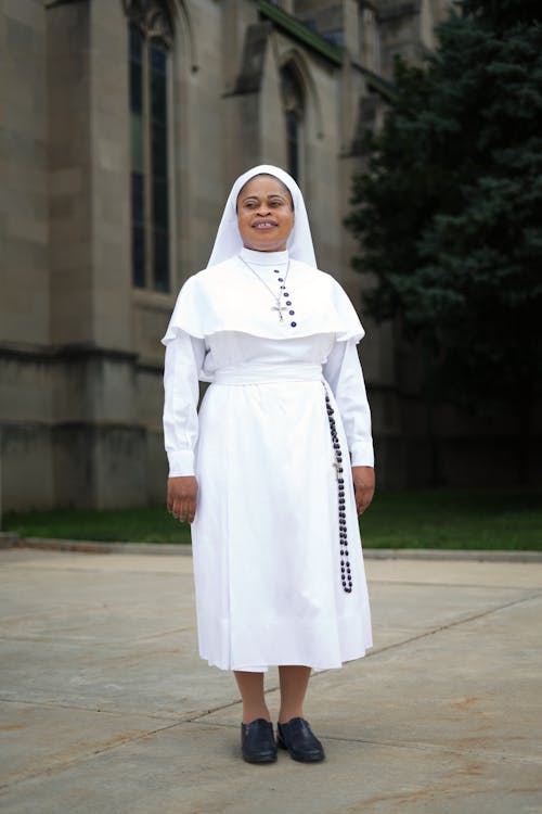 Free A Nun in White Religious Habit Standing Outside Stock Photo