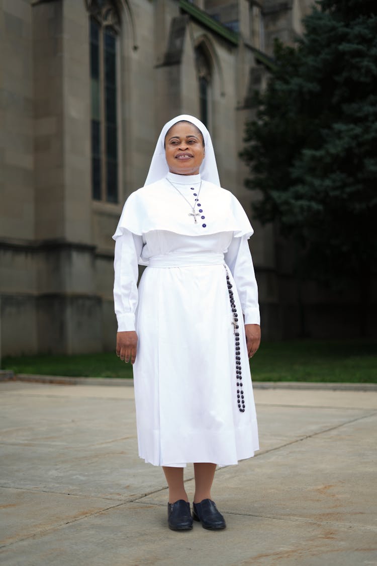 A Nun In White Religious Habit Standing Outside