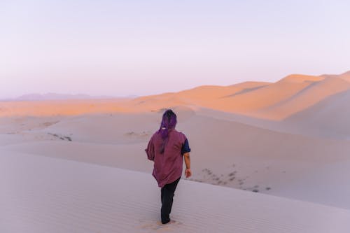 A Woman Standing on the Desert Sand