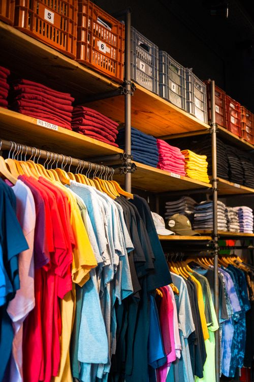 Free Vibrant t-shirts neatly displayed in an organized boutique setting. Stock Photo
