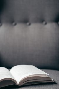 Open book resting on a couch — photo by Anete Lusina on Pexels