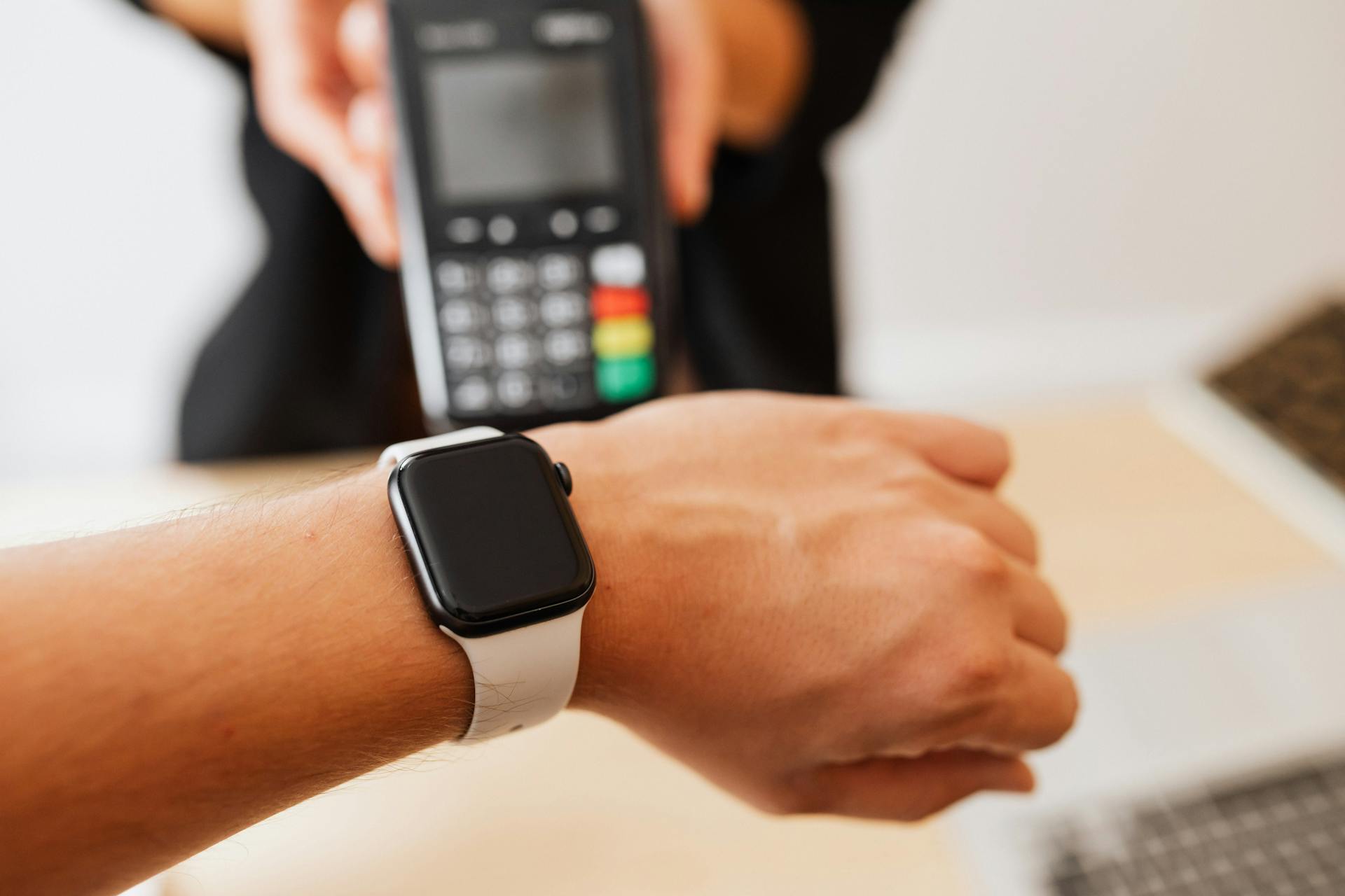 A Person Using a Smartwatch for Payment