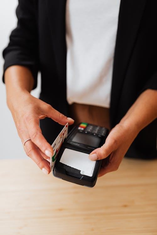 A Person Holding Black Payment Terminal