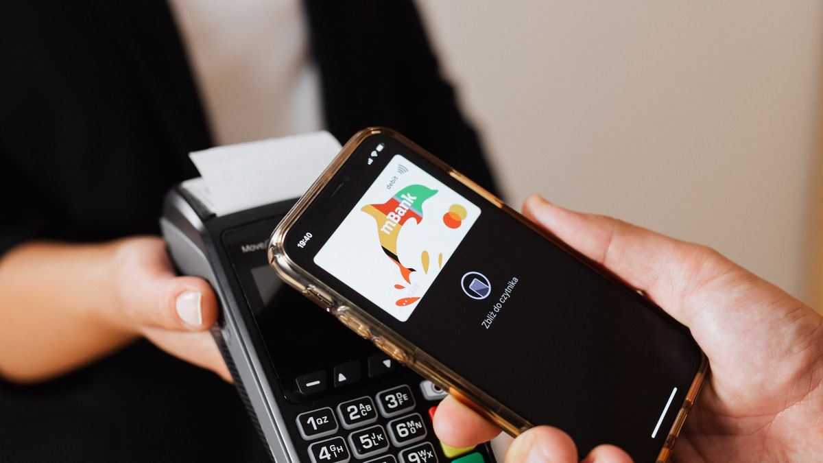 Person completing a mobile payment on a phone