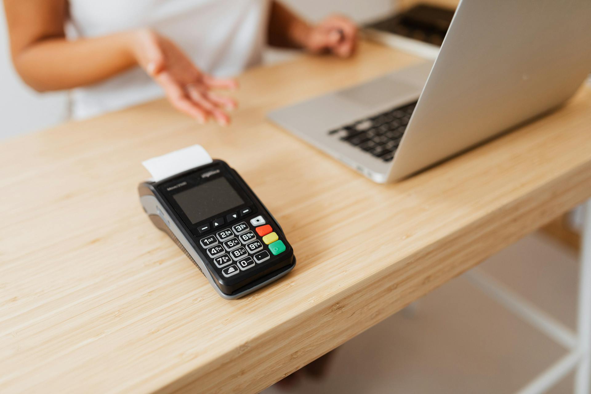 Black Payment Terminal on Brown Wooden Table