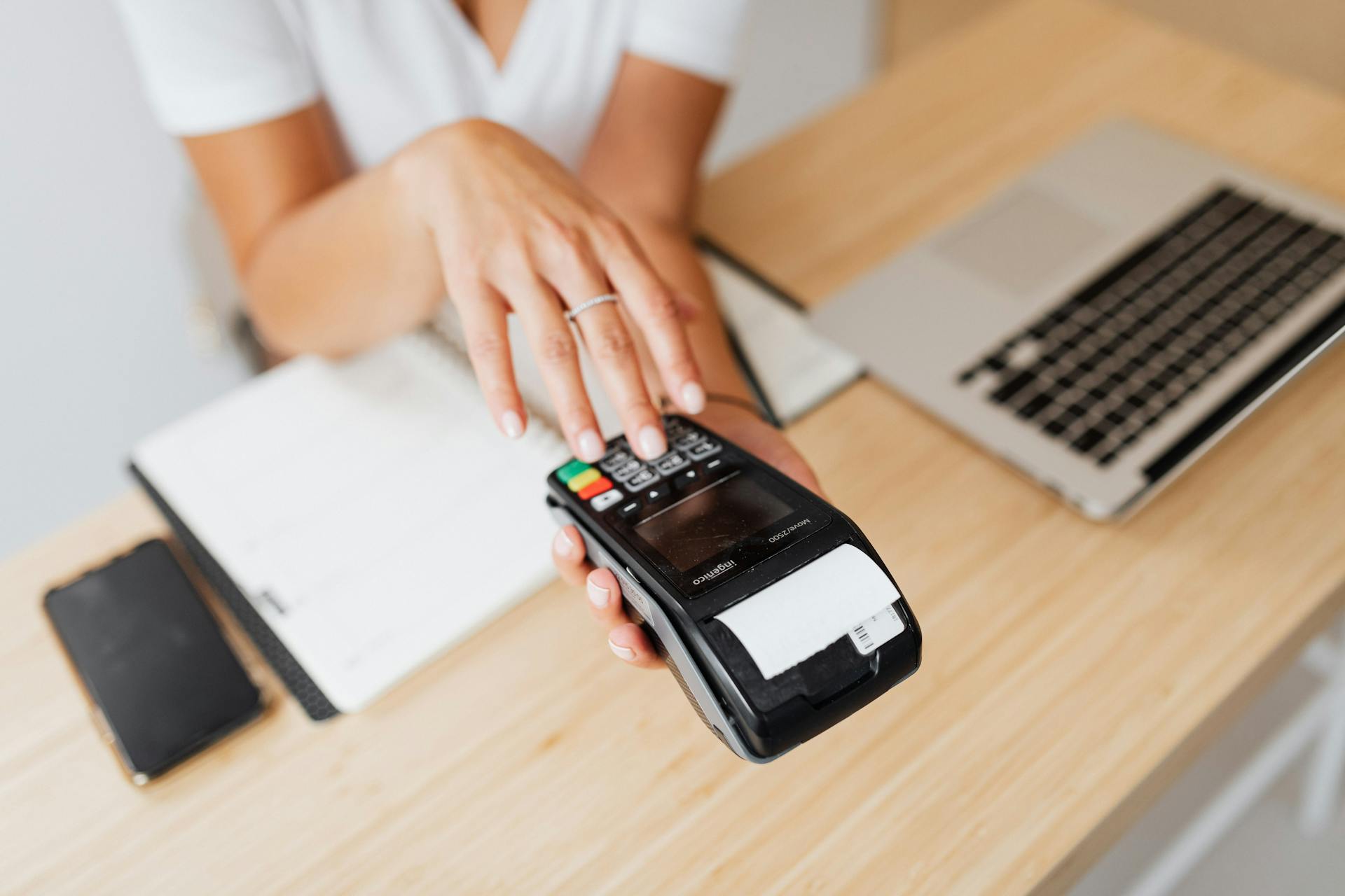 A Person Pressing on a Payment Terminal