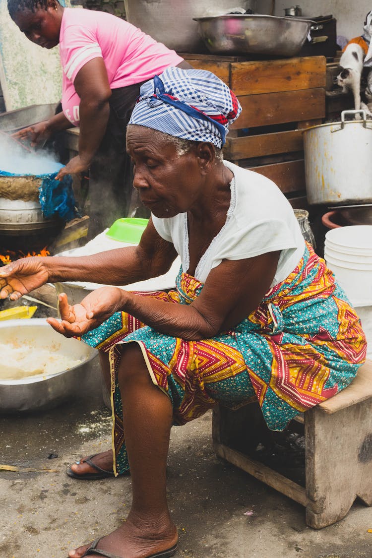 Old Woman In Traditional Clothes At Market