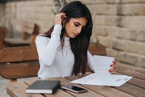 Ethnic young woman reading notes