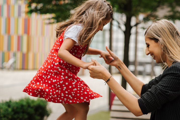 Mother Playing With Daughter On Playground