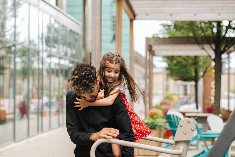 Father Giving Piggyback Ride To Daughter