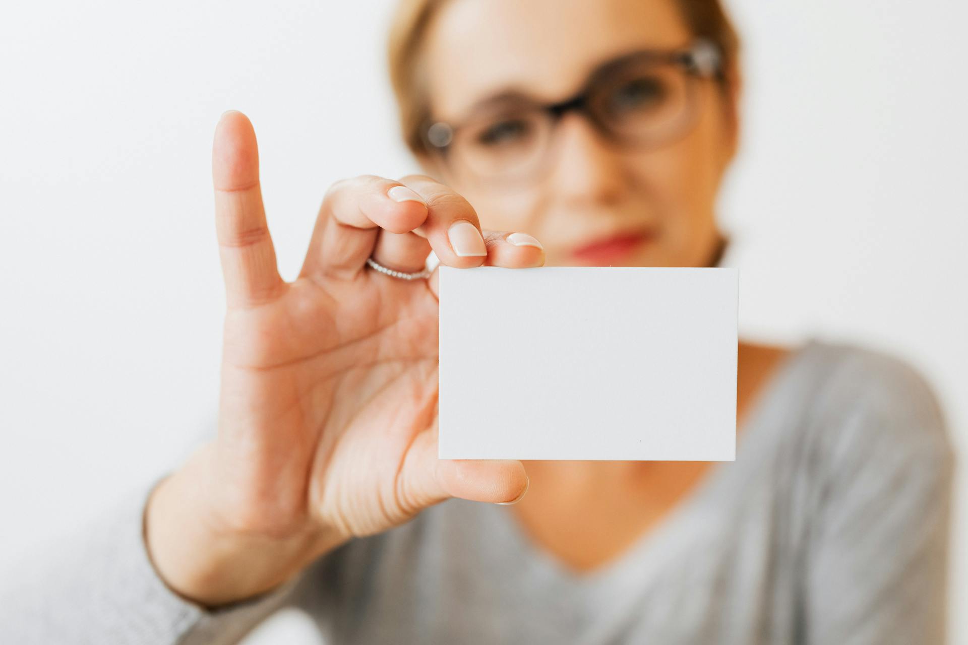 A Woman Holding a Blank Card