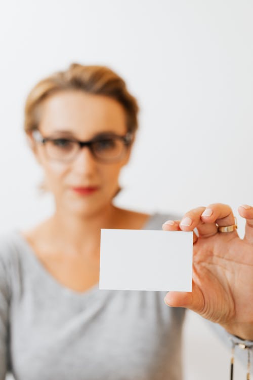 A Woman Holding a Blank Card