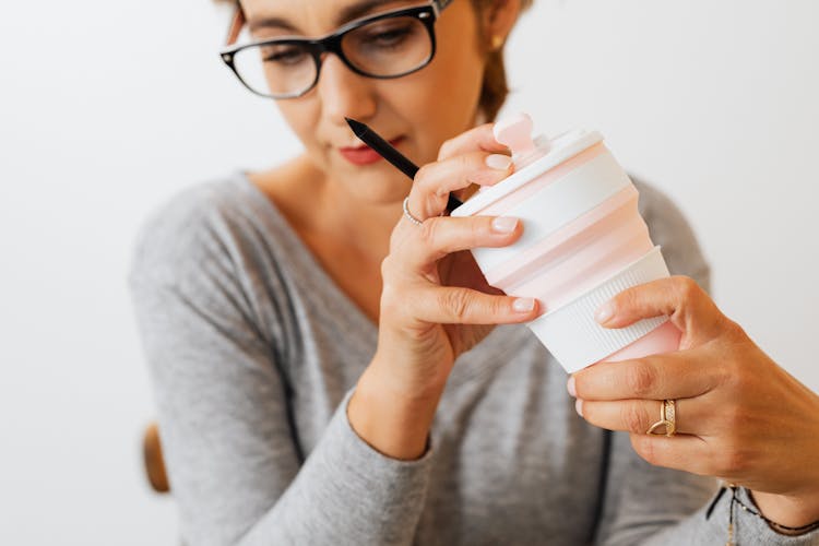 Woman Holding A Foldable Reusable Cup 