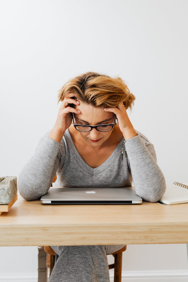 Woman In Gray Long Sleeves Wearing Eyeglasses