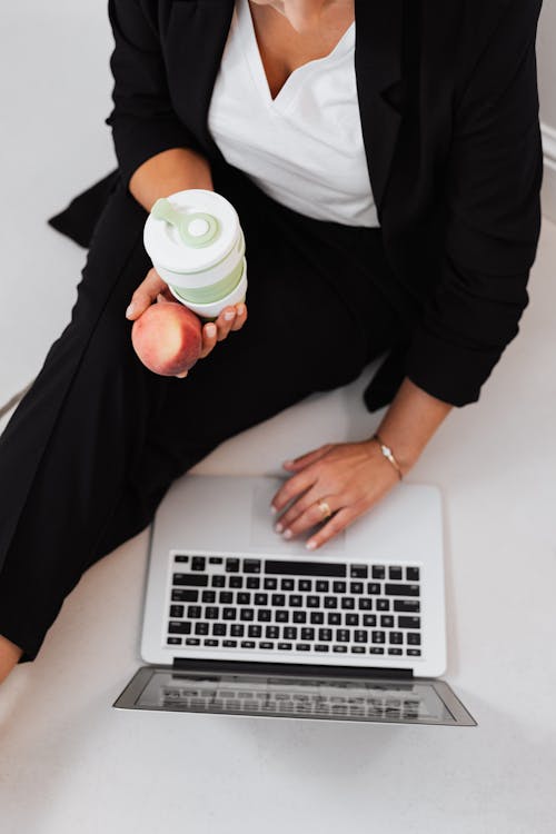 Free Person Sitting on the Floor Using a Laptop Stock Photo