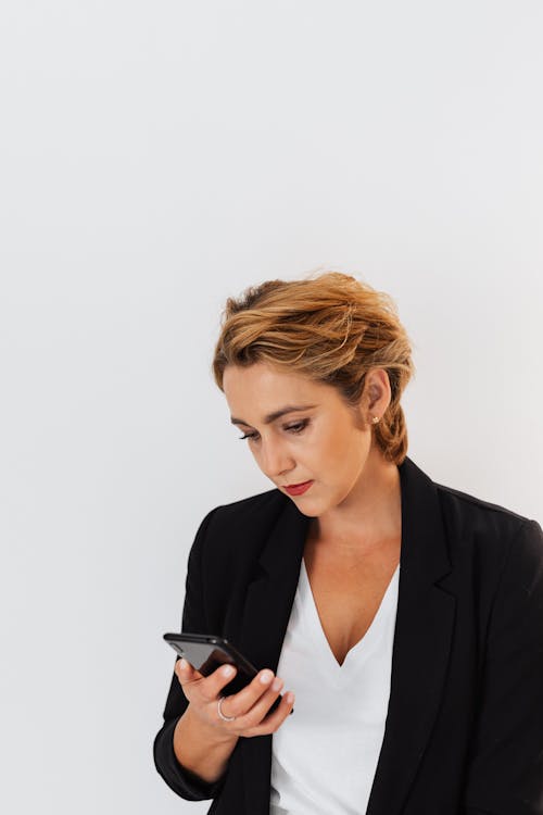 Woman in Black Blazer using Smartphone